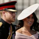Prince Harry and wife Meghan Markle leave the UK's Royal Palace