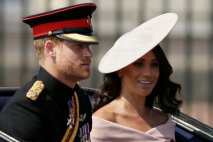 Prince Harry and wife Meghan Markle leave the UK's Royal Palace