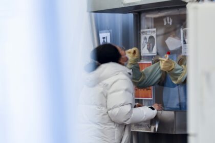 Seoul : A citizen undergoes a COVID-19 test at a makeshift testing station at Seoul's Yongsan Station on Jan. 22, 2022. South Korea reported 7,009 new cases on the day amid the continued spread of the highly transmissible omicron variant.(Yonhap/IANS)