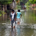 Bajali: People wade through flood water in flood-hit Bajali district of Assam, Friday, June 23, 2023. (Photo: Anuwar hazarika/IANS)