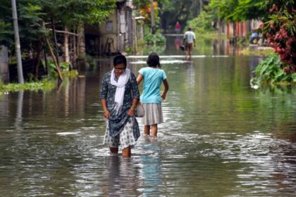 Bajali: People wade through flood water in flood-hit Bajali district of Assam, Friday, June 23, 2023. (Photo: Anuwar hazarika/IANS)