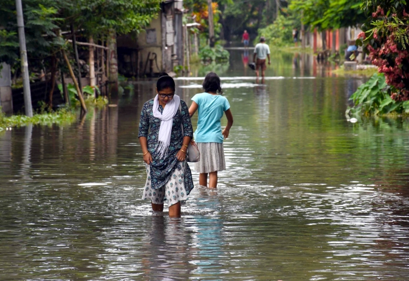 Bajali: People wade through flood water in flood-hit Bajali district of Assam, Friday, June 23, 2023. (Photo: Anuwar hazarika/IANS)