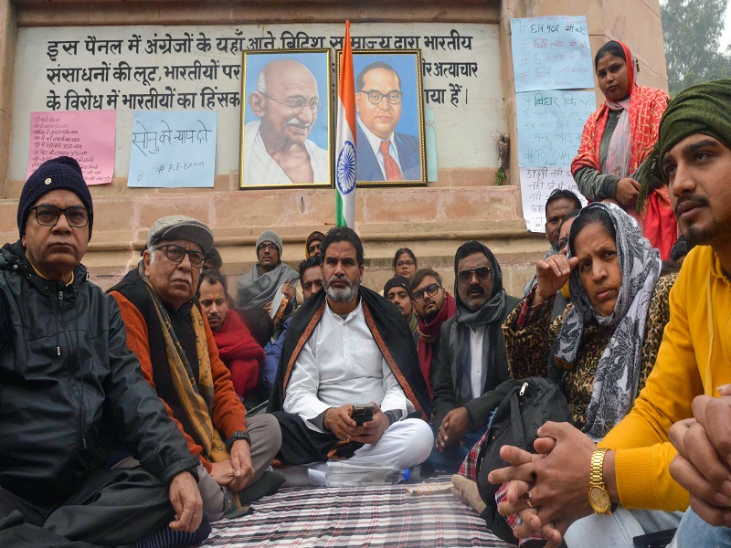 Patna: Jan Suraaj chief Prashant Kishor with others during an indefinite hunger strike demanding the cancellation of the 70th Integrated Combined Competitive (Preliminary) Examination (CCE), 2024, conducted by the BPSC, over allegations of a question paper leak near the Mahatma Gandhi statue in Patna on Sunday, January 05, 2025. (Photo: IANS)